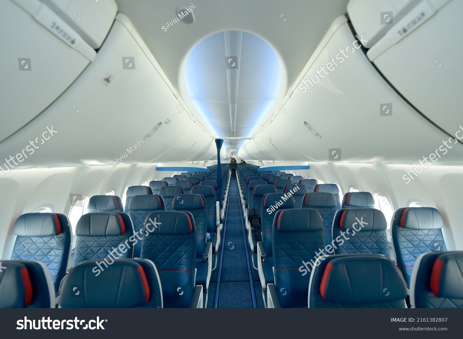 stock photo empty interior of modern airplane boeing max with blue seats and no passangers 2161382807